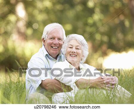 Stock Photograph - Senior Couple Sitting In Park. Fotosearch