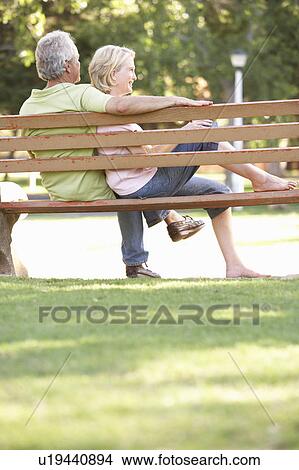 Senior Couple Sitting Together On Park Bench View Large Photo Image Picture - Senior Couple Sitting Together On Park Bench. Fotosearch