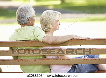 Senior Couple Sitting Together On Park Bench View Large Photo Image Picture - Senior Couple Sitting Together On Park Bench. Fotosearch