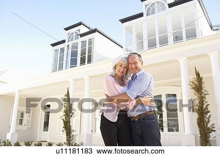 Senior Couple Standing Outside Dream Home View Large Photo Image Stock Image - Senior Couple Standing Outside Dream Home. Fotosearch