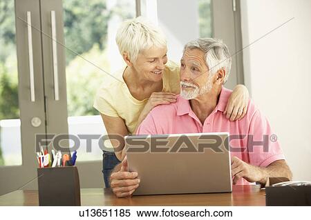 Senior Couple Using Laptop At Home View Large Photo Image Stock Photography - Senior Couple Using Laptop At Home. Fotosearch