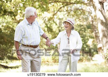 Senior Couple Walking In Park View Large Photo Image Stock Photo - Senior Couple Walking In Park. Fotosearch