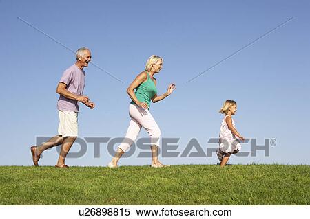 Senior couple, with granddaughter, running though field View Large Photo Image Stock Photography - Senior couple, with granddaughter, running though field. Fotosearch