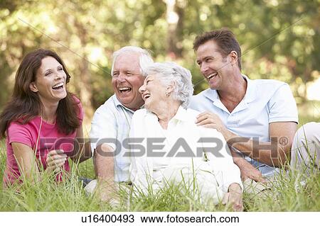 Stock Image - Senior Couple With Grown Up Children In Park. Fotosearch