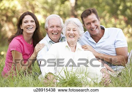 Stock Photo - Senior Couple With Grown Up Children In Park. Fotosearch
