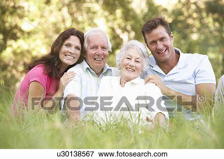 Stock Photo - Senior Couple With Grown Up Children In Park. Fotosearch