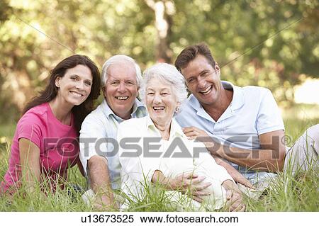 Stock Photography - Senior Couple With Grown Up Children In Park. Fotosearch