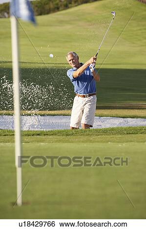 Senior Male Golfer Playing Bunker Shot On Golf Course View Large Photo Image Stock Photograph - Senior Male Golfer Playing Bunker Shot On Golf Course. Fotosearch