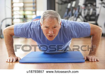 Stock Photo - Senior Man Doing Press Ups In Gym. Fotosearch
