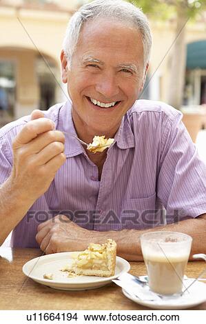 Senior Man Enjoying Coffee And Cake In Café View Large Photo Image Picture - Senior Man Enjoying Coffee And Cake In Café. Fotosearch
