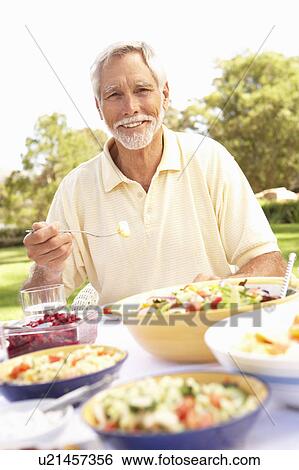 Senior Man Enjoying Meal In Garden View Large Photo Image Stock Photograph - Senior Man Enjoying Meal In Garden. Fotosearch