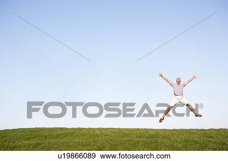 Stock Photo - Senior man jumping in air. Fotosearch