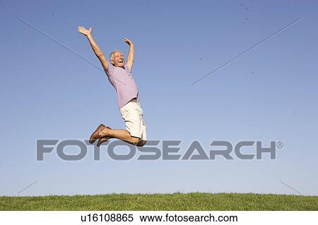Stock Photography - Senior man jumping in air. Fotosearch