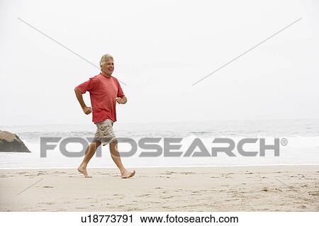 Senior Man On Holiday Running Along Winter Beach View Large Photo Image Stock Image - Senior Man On Holiday Running Along Winter Beach. Fotosearch