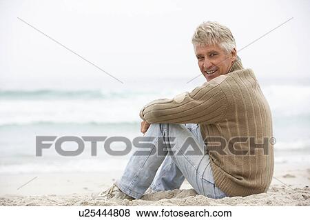 Senior Man On Holiday Sitting On Winter Beach View Large Photo Image Stock Photo - Senior Man On Holiday Sitting On Winter Beach. Fotosearch