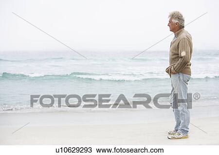 Senior Man On Holiday Standing On Winter Beach View Large Photo Image Stock Image - Senior Man On Holiday Standing On Winter Beach. Fotosearch