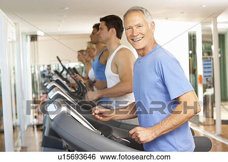 Stock Photograph - Senior Man On Running Machine In Gym. Fotosearch