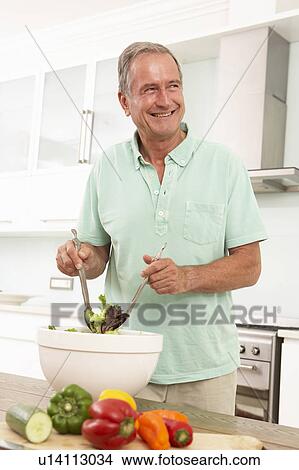 Senior Man Preparing Salad In Modern Kitchen View Large Photo Image Picture - Senior Man Preparing Salad In Modern Kitchen. Fotosearch
