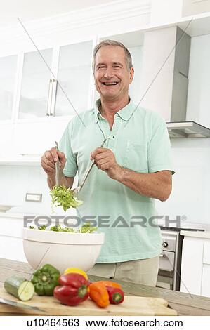 Senior Man Preparing Salad In Modern Kitchen View Large Photo Image Stock Image - Senior Man Preparing Salad In Modern Kitchen. Fotosearch