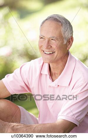 Stock Image - Senior man relaxing in a park. Fotosearch
