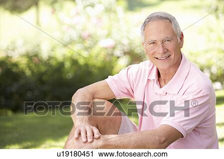 Stock Image - Senior man relaxing in a park. Fotosearch