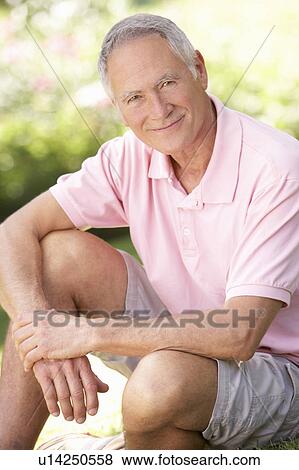 Senior man relaxing in a park View Large Photo Image Stock Photo - Senior man relaxing in a park. Fotosearch