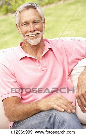 Stock Photo - Senior Man Relaxing In Garden. Fotosearch