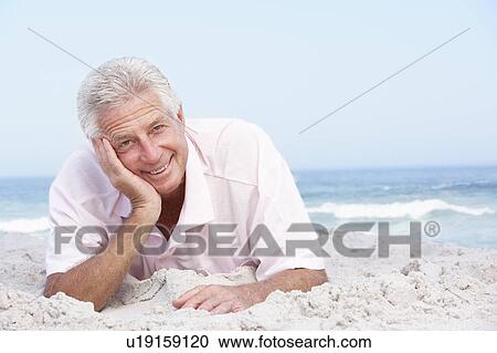 Senior Man Relaxing On Sandy Beach View Large Photo Image Stock Image - Senior Man Relaxing On Sandy Beach. Fotosearch