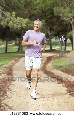Senior man running in park View Large Photo Image Stock Image - Senior man running in park. Fotosearch