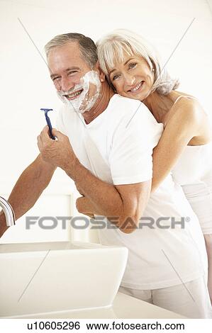 Senior Man Shaving In Bathroom Mirror With Wife Watching View Large Photo Image Stock Photograph - Senior Man Shaving In Bathroom Mirror With Wife Watching. Fotosearch