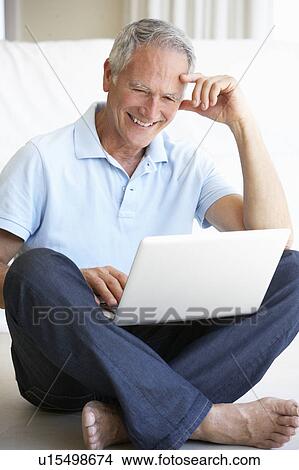 Senior man using laptop computer View Large Photo Image Picture - Senior man using laptop computer. Fotosearch