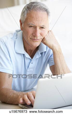 Senior man using laptop computer View Large Photo Image Stock Image - Senior man using laptop computer. Fotosearch