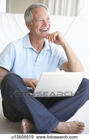 Senior man using laptop computer View Large Photo Image Stock Photo - Senior man using laptop computer. Fotosearch