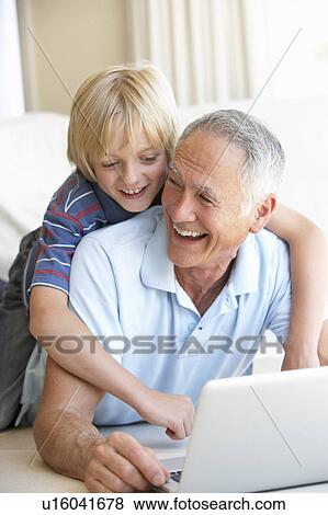 Senior man with young boy using laptop computer View Large Photo Image Stock Photo - Senior man with young boy using laptop computer. Fotosearch