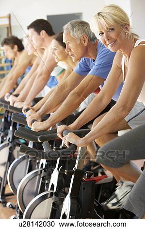 Senior Woman Cycling In Spinning Class In Gym View Large Photo Image Stock Image - Senior Woman Cycling In Spinning Class In Gym. Fotosearch