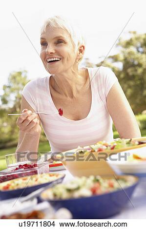 Senior Woman Enjoying Meal In Garden View Large Photo Image Picture - Senior Woman Enjoying Meal In Garden. Fotosearch