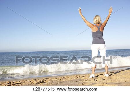 Senior Woman In Fitness Clothing Stretching On Beach View Large Photo Image Stock Photography - Senior Woman In Fitness Clothing Stretching On Beach. Fotosearch