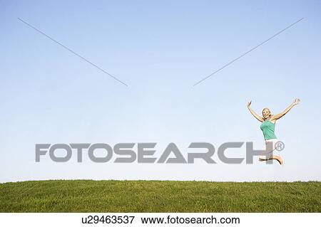 Senior woman jumping in air View Large Photo Image Stock Photo - Senior woman jumping in air. Fotosearch
