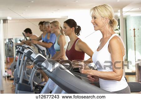 Stock Image - Senior Woman On Running Machine In Gym. Fotosearch