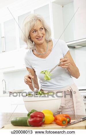 Senior Woman Preparing Salad In Modern Kitchen View Large Photo Image Stock Image - Senior Woman Preparing Salad In Modern Kitchen. Fotosearch