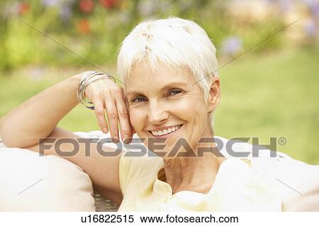 Stock Photography - Senior Woman Relaxing In Garden. Fotosearch