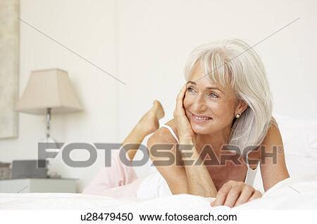 Senior Woman Relaxing On Bed View Large Photo Image Stock Image - Senior Woman Relaxing On Bed. Fotosearch