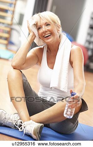 Senior Woman Resting After Exercises In Gym View Large Photo Image Stock Photograph - Senior Woman Resting After Exercises In Gym. Fotosearch
