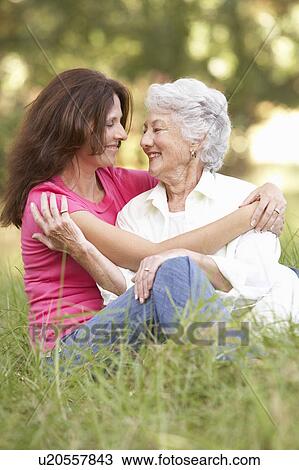 Senior Woman With Adult Daughter In Park View Large Photo Image Stock Image - Senior Woman With Adult Daughter In Park. Fotosearch