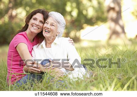 Senior Woman With Adult Daughter In Park View Large Photo Image Stock Photo - Senior Woman With Adult Daughter In Park. Fotosearch
