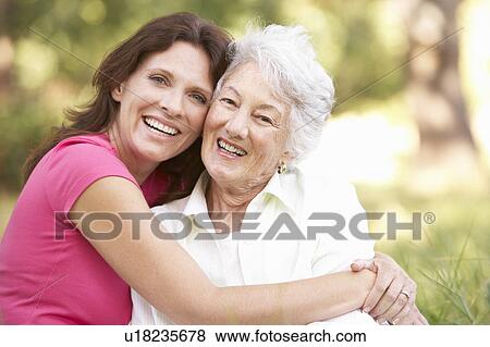 Senior Woman With Adult Daughter In Park View Large Photo Image Stock Photo - Senior Woman With Adult Daughter In Park. Fotosearch