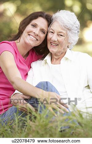 Stock Photo - Senior Woman With Adult Daughter In Park. Fotosearch