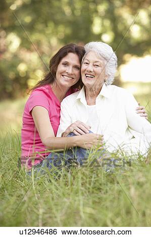 Stock Photograph - Senior Woman With Adult Daughter In Park. Fotosearch