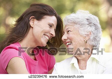 Senior Woman With Adult Daughter In Park View Large Photo Image Stock Photograph - Senior Woman With Adult Daughter In Park. Fotosearch