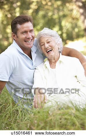 Senior Woman With Adult Son In Garden View Large Photo Image Stock Image - Senior Woman With Adult Son In Garden. Fotosearch